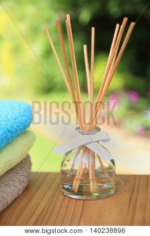 Aromatherapy Reed Difuser Bottle In A Beautiful Outdoor Setting In Morning Sunlight