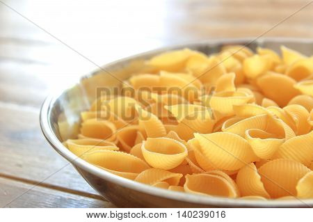 Dry Conchiglie Pasta Shells In A Stainless Steel Bowl