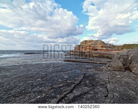 Long exposure shot on amazing pink rocks and sea