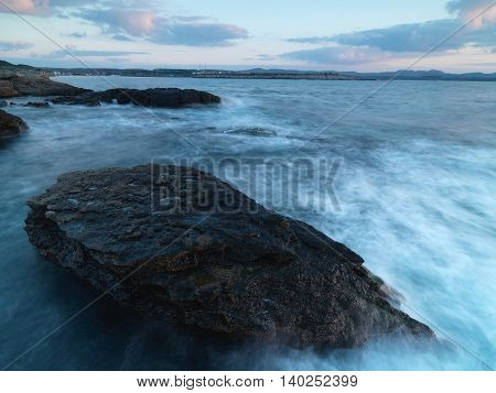 Long exposure shot on amazing pink rocks and sea