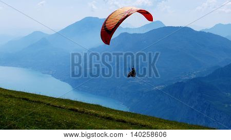 Paraglider at Monte Baldo, over the Lake Garda