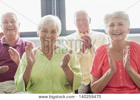 Seniors clapping hands in a retirement home