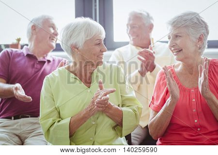 Seniors clapping hands in a retirement home