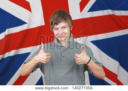 Young British Boy Two Thumbs up in Front of Union Jack Flag