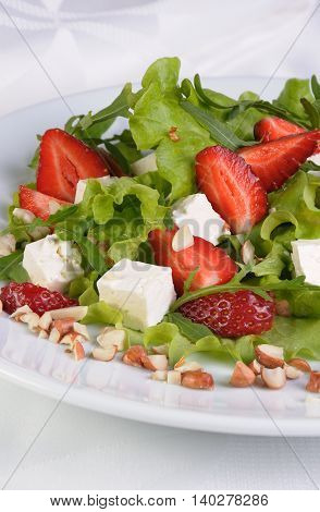 Salad of lettuce arugula strawberries feta cheese and peanuts