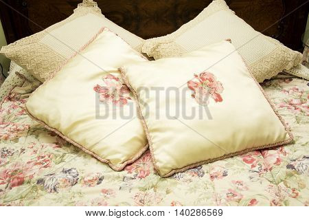 Photo of several cushions with suft colours and electriclight