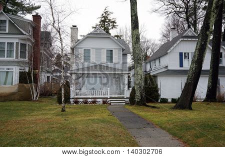 WEQUETONSING, MICHIGAN / UNITED STATES - DECEMBER 22, 2015: The front porch, of a small home on Beach Drive in Wequetonsing, is protected with plastic sheeting from the winter weather.