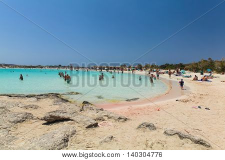 Elafonisi, Island Crete, Greece, - June 26, 2016: Swimming and relaxing people  on the beautiful beach of Elafonisi with pink sand