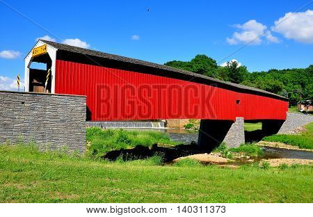 Asheville Pennsylvania - June 6 2015: 1884 vernacular Burr arch-truss wooden covered bridge over the Octoraro Creek *