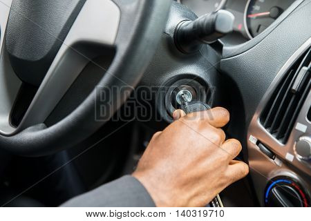 Close-up Of Person's Hand Inserting Key To Start Car