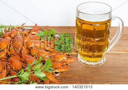boiled crayfish with parsley on a wooden table