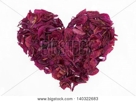Vintage beautiful heart shape made from dry peony petals isolated on white background