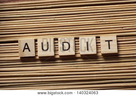 AUDIT word written on wood abc block.