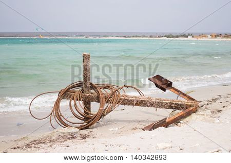 Old large anchor lying on the beach