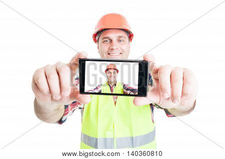 Cheerful Builder Using Phone To Take Photograph