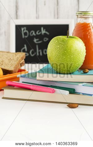 Back to school concept, lunchbox, apple and carrot juice. Selective focus