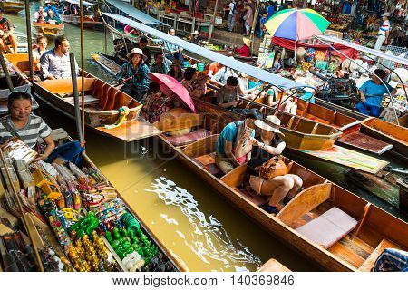 Damnoen Saduak Thailand-20 March 2016. Busy sunday morning at Damnoen Saduak floating marketRatchaburi Thailand place of locals selling fresh produce cooked food and souvenirs.