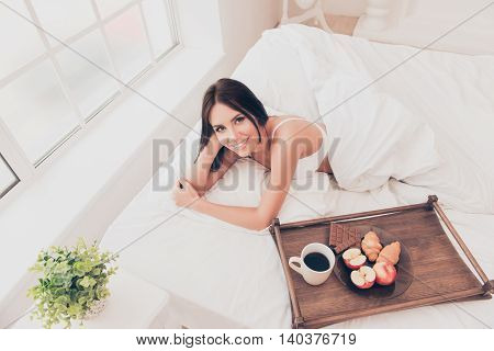Happy Girl In Bed With Wooden Tray With Tasty Breackfast