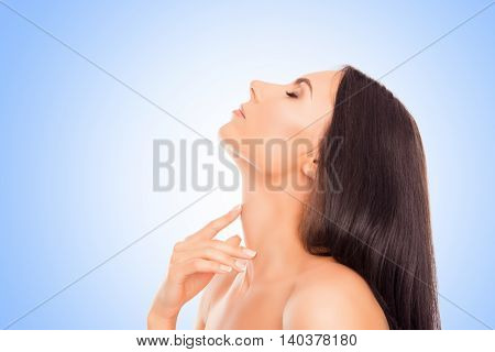 Sensitive Relaxed Woman Touching Her Neck On Blue Background
