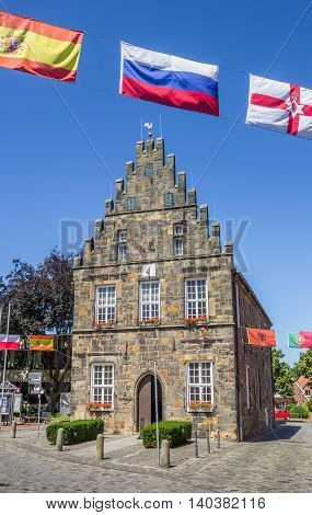 SCHUTTORF, GERMANY - JULY 19, 2016: Old city hall with flags in Schuttorf, Germany