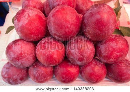 Fresh ripe red plums on market thai