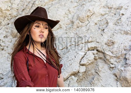 girl in a cowboy hat standing at the white cliffs