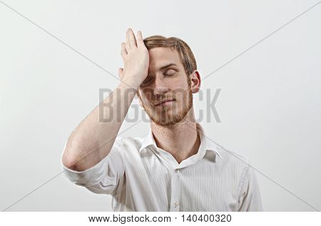 Young Adult Male Wearing White Shirt Gesturing He Has Made a Big Mistake