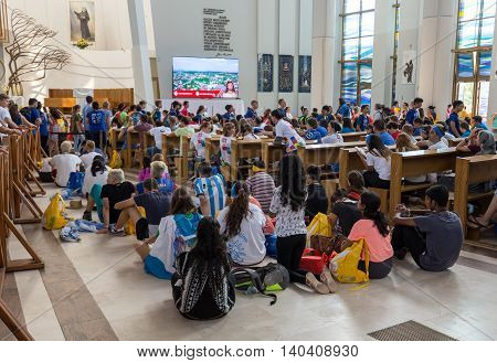 CRACOW POLAND - JULY 26 2016: World Youth Day 2016 - Crowd of Pilgrims inside of the Sanctuary of Divine Mercy in Lagiewniki. Cracow Poland