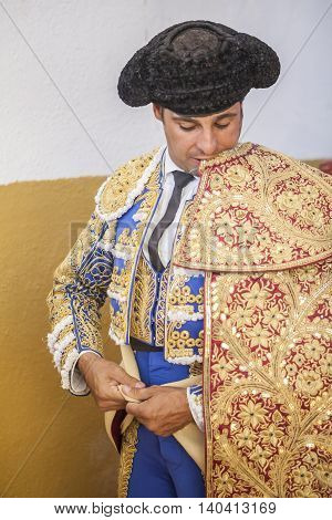 Sabiote Spain - September 9 2011: Spanish bullfighter Francisco Rivera putting itself the walk cape in the alley before going out to fight typical and very ancient tradition in Spain