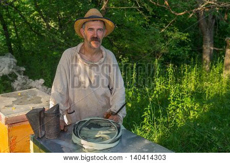 Portrait of Ukrainian bee-keeper on his apiary