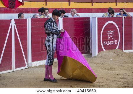 Sabiote Spain - August 23 2014: The Spanish Bullfighter bullfighting with the crutch in the Bullring of Sabiote Spain