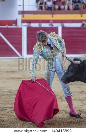 Sabiote Spain - August 23 2014: The Spanish Bullfighter Manuel Escribano bullfighting with the crutch in the Bullring of Sabiote Spain