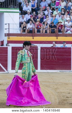Sabiote Spain - August 23 2014: The Spanish Bullfighter Adrian de Torres bullfighting with the crutch in the Bullring of Sabiote Spain