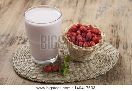 Smoothies with fresh strawberry with yogurt on a wooden table.