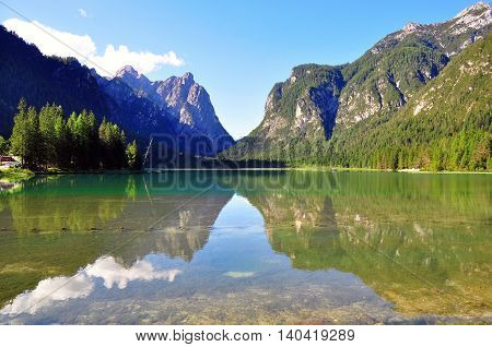 Reflections of Dobbiaco lake in northern Italy
