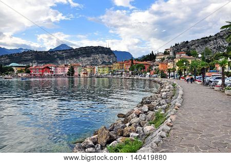 NAGO-TORBOLE ITALY - JULY 27: Promenade in old town of Nago-Torbole Italy on July 27 2014. Nago-Torbole is a resort on northern part of Garda lake in Italy.