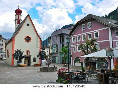 ORTISEI ITALY - JUNE 26: View of the main square of Ortisei town Italy on June 26 2014. Ortisei is a ski resort in Dolomites Alps Italy.