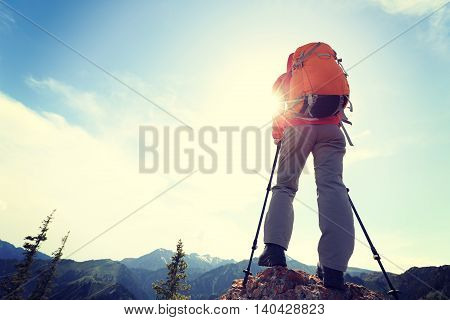successful woman backpacker enjoy the view on mountain peak