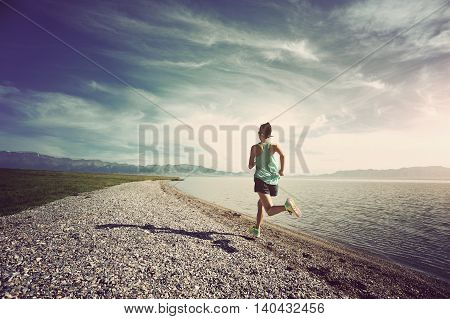 healthy young fitness woman runner running on seaside trail