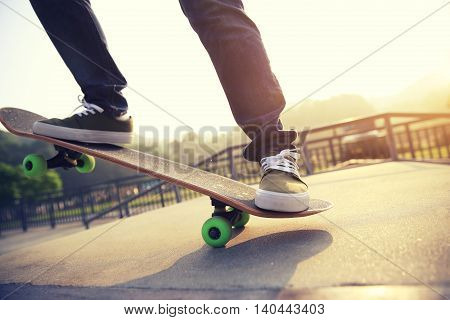 one young skateborder skateboarding at skatepark ramp
