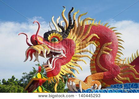 Red big dragon statue in public place of worship Chonburi province Thailand.