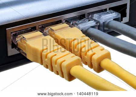 Network hub with plugged ethernet cables LAN isolated on white background with clipping path closeup