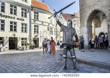 Tallinn Estonia - July 29th 2016: medieval warrier in Old City Tallinn. Writing on the wall reads: 'The House of Hopner'