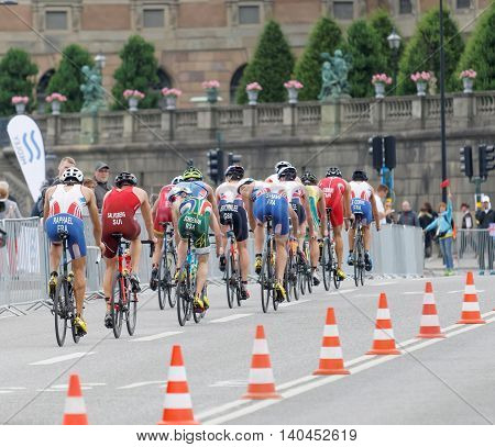 STOCKHOLM SWEDEN - JUL 02 2016: Rear view of a large group of male triathlete cyclists in the Men's ITU World Triathlon series event July 02 2016 in Stockholm Sweden