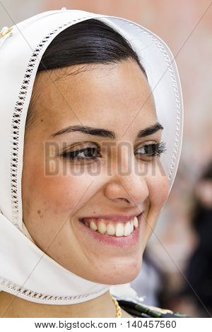 CAGLIARI, ITALY - May 1, 2014: 358 ^ Religious Procession of Sant'Efisio - Sardinia - portrait of a beautiful smiling girl in traditional Sardinian costume