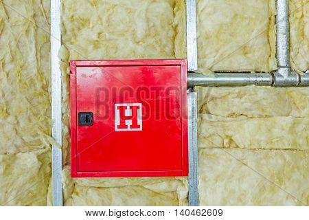 Front side of fire box with symbol for hydrant in an unfinished party wall.