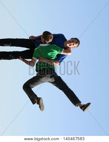 Man holding another man in strange pose. Gravitation not working for them