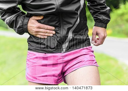Man runner side cramps after running outdoors