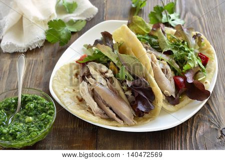 Tacos with chicken and vegetable salad with green sauce