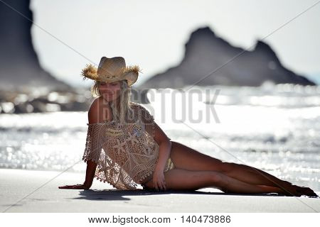 young woman relaxing on the beach in summer day